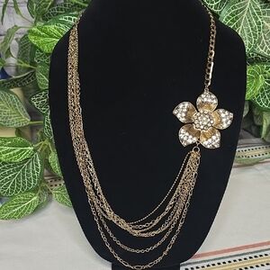 Gold Tone Necklace With A Rhinestone Accented Flower